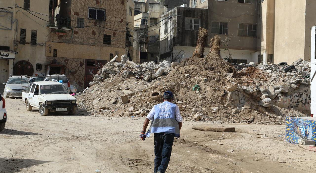 Un treballador de la UNRWA entre els enderrocs d'un bombardeig, a Gaza
